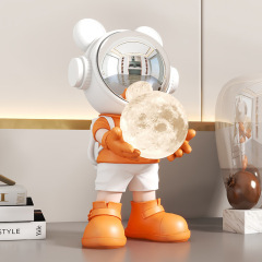 創意的で贅沢な宇宙飛行士のデスクトップは家庭のリビングルームの子供の部屋の月の電気スタンドのお土産を飾っています。