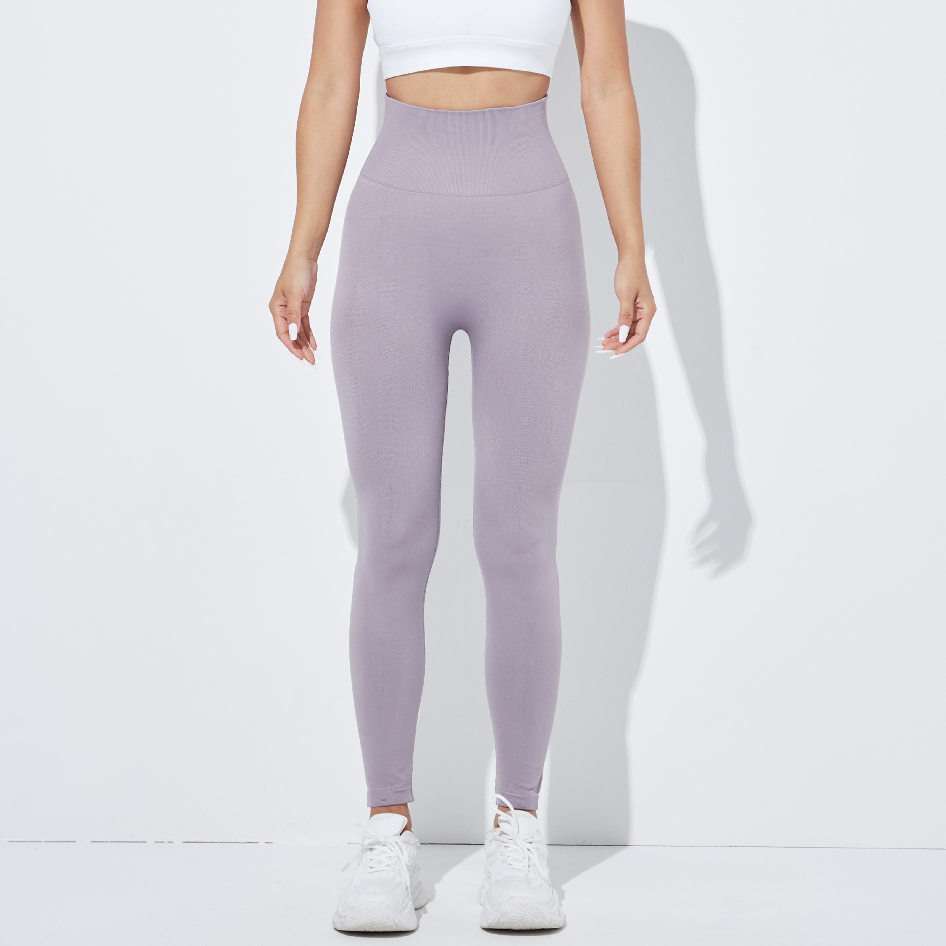Pantalones de yoga europeos y americanos sin costuras transfronterizas pantalones de fitness deportivos de levantamiento de cadera apretados de mujer ropa de Yoga de melocotón de cintura alta lisa