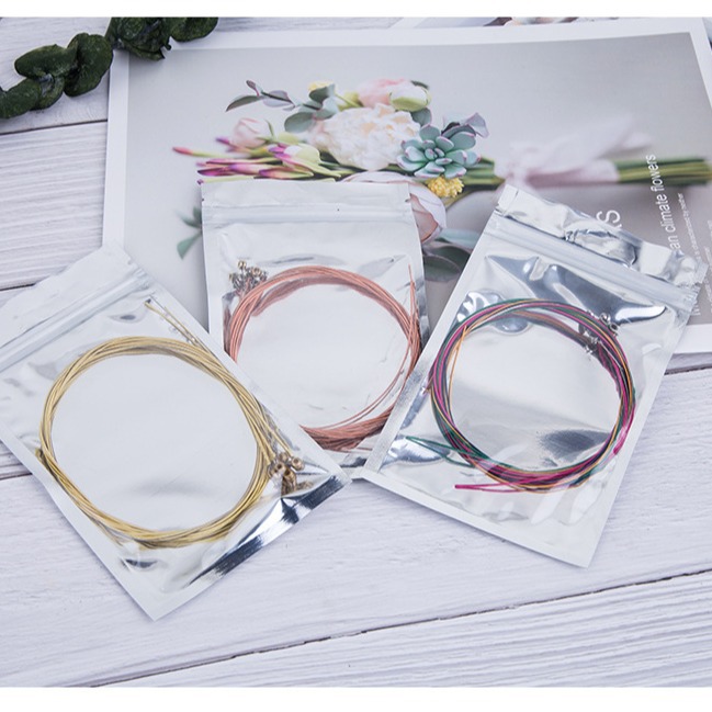 Fabricante de cuerdas para guitarra, venta al por mayor de cuerdas de latón, cuerdas de cobre rojo, juegos de cuerdas de colores, líneas de cuerdas para ukelele, guitarra eléctrica y guitarra acústica.