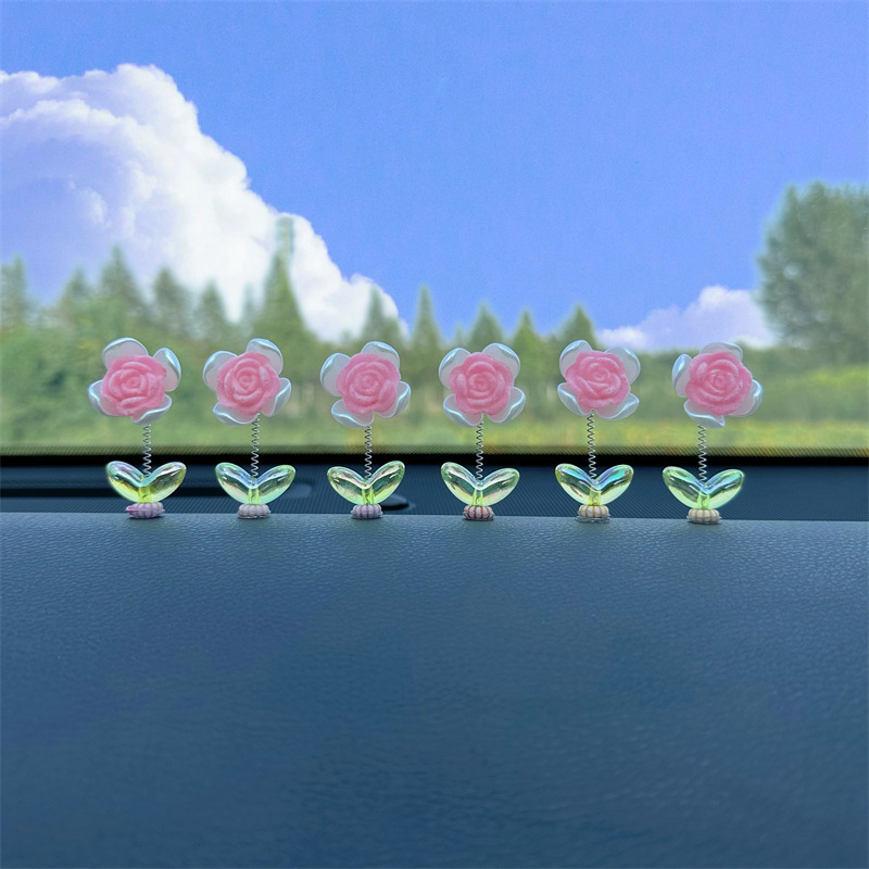 Tendencia nuevo producto flocado rosa coche sacudiendo la cabeza pequeños adornos decoración de primavera tablero accesorios de coche ventana