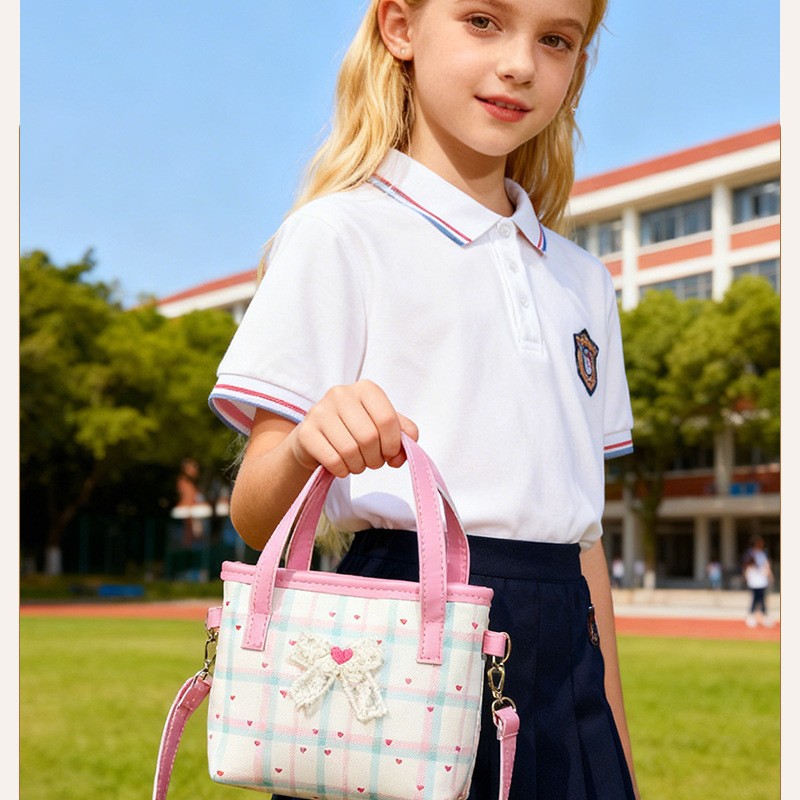 2026 nuevo bolso de niños lindos arcos de encaje bolsos de hombro para hombres y mujeres dulce bolso de mano para bebés