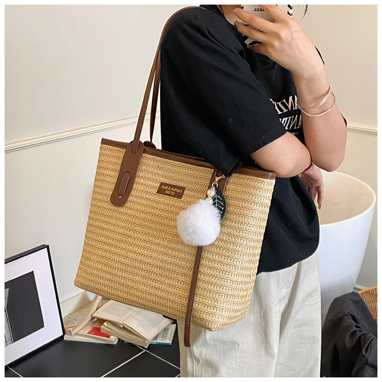 This is a new 2025 summer beach-style women's bag with a simple and versatile hand-held design. It's a single-shoulder vacation woven bag undefined