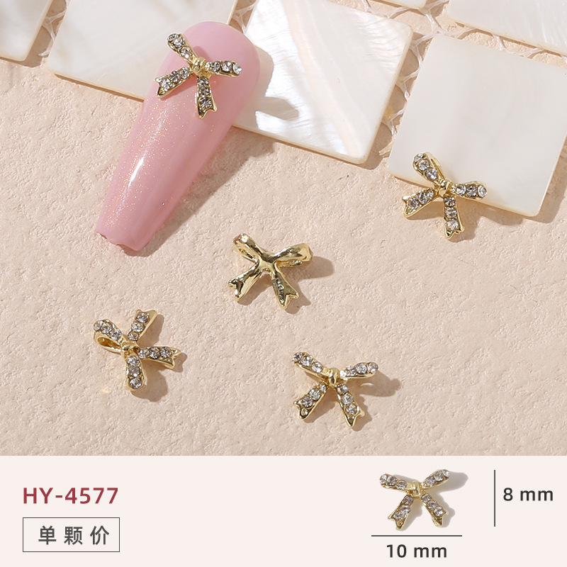 Uñas mariposa joyería nueva línea popular perla arco metal decoración de uñas pequeños accesorios de joyería al por mayor