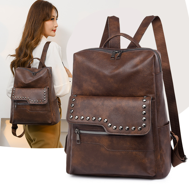 Venta directa de fábrica primavera nueva mochila de cuero suave para mujer de color sólido moda retro de gran capacidad mochila de viaje al aire libre