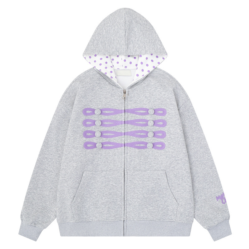 Hooded zip-up sweatshirt with purple polka dot lining, front purple button design, front kangaroo pocket, and loose cuffs Hooded zip-up sweatshirt with purple polka dot lining, front purple button design, front kangaroo pocket, and loose cuffs