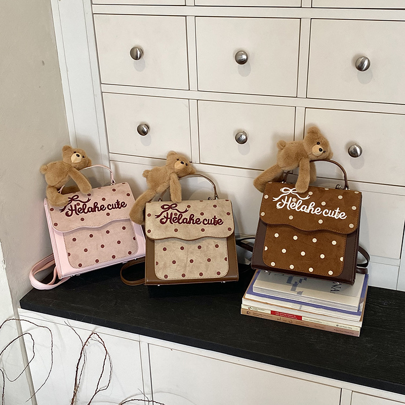Korean-style preppy backpack for kindergarten children, featuring a trendy letter and polka dot design, and a cute little bear