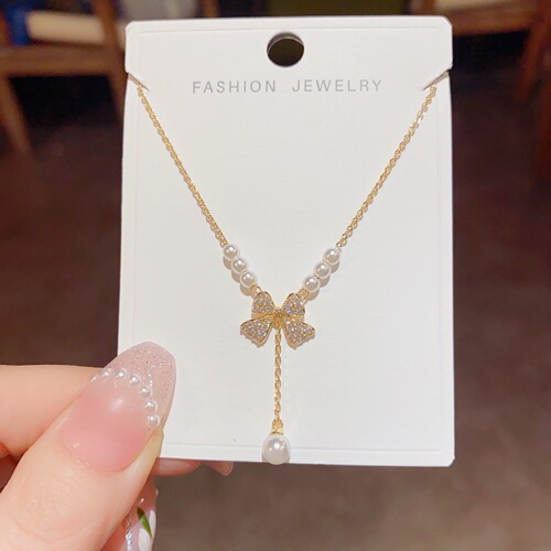 Sweet niche light luxury jewelry women's new bow pearl necklace pendant clavicle chain sweater chain