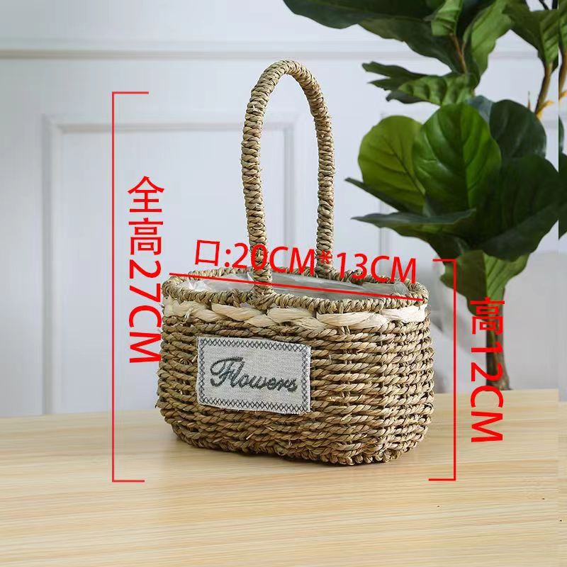 Fabricantes de cestas de flores ovales rectas de paja hechas a mano en stock al por mayor cestas de flores de paja portátiles decoración de viento pastoral