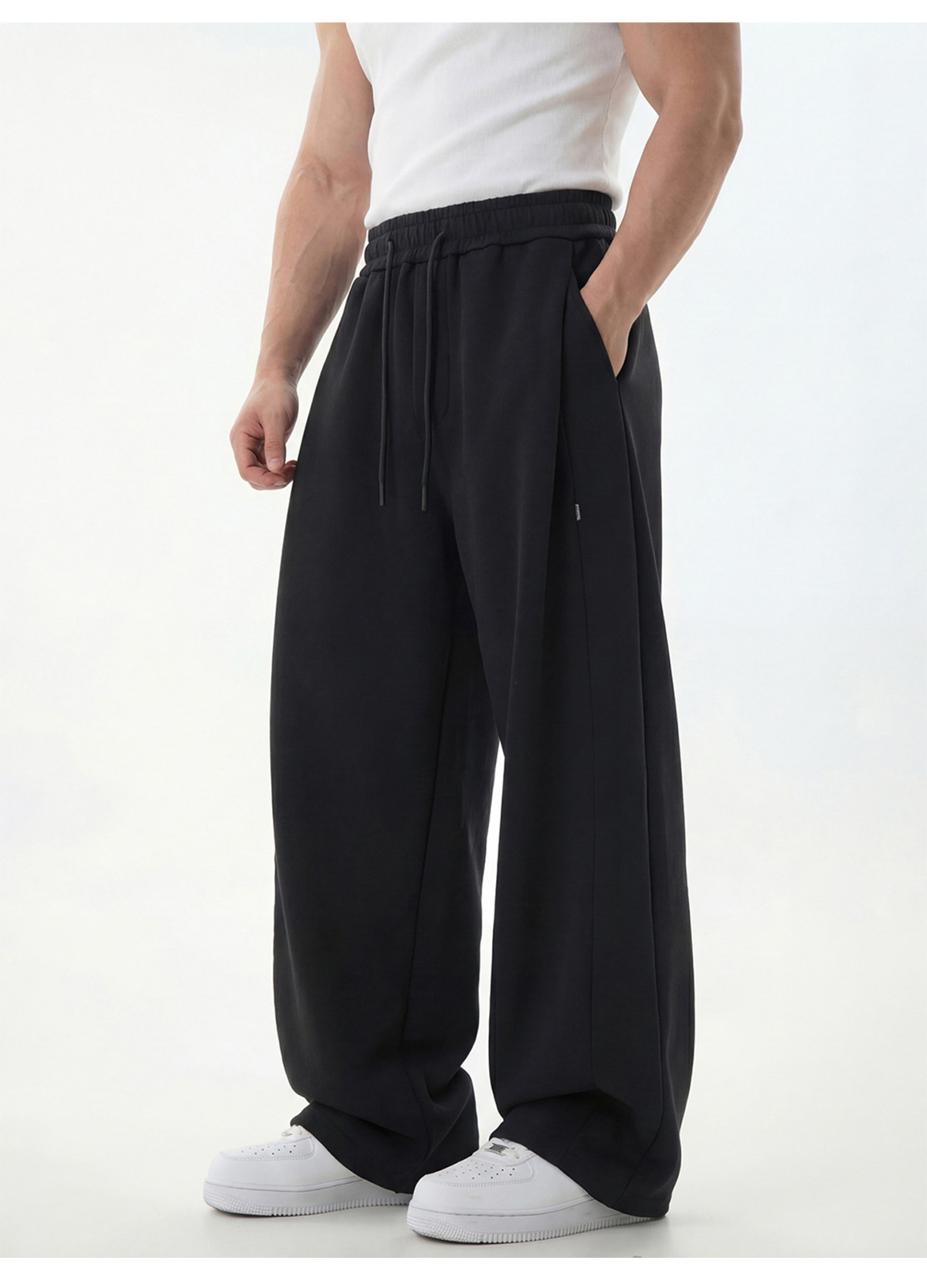 Pantalon de jogging pour homme à empiècements texturés, coutures asymétriques modernes, entrejambe basse, coupe décontractée, tombé impeccable._voghion.com