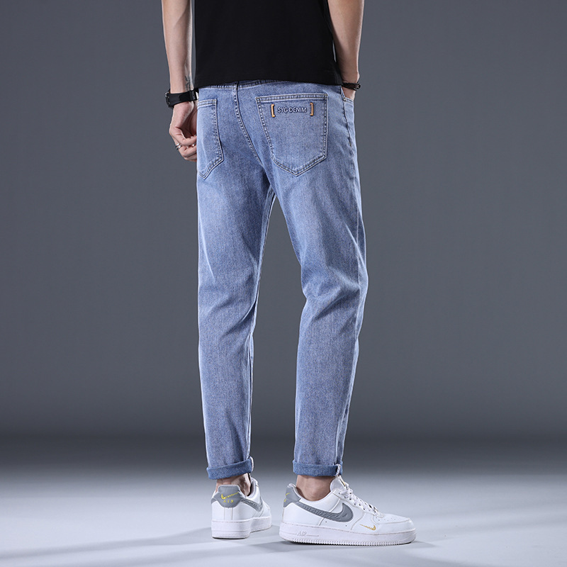 European-style men's jeans, trendy slim fit, stretchy, light blue, versatile, stylish, straight leg casual pants for young men.