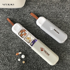 新型家庭用携帯小薬箱分注薬箱老人は薬箱ミニ錠剤分注箱を持っています。