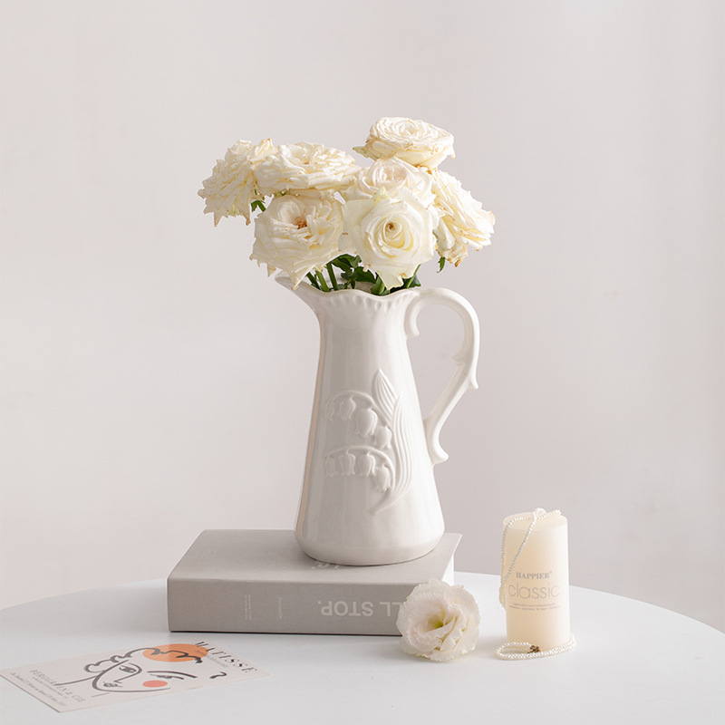A Nordic-style white ceramic vase with embossed decoration, featuring dried flowers and plants, suitable for a living room, TV cabinet, and as a high-end decorative piece.
