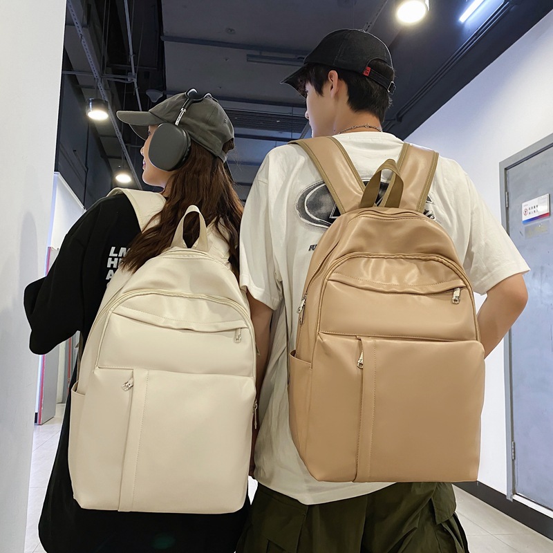 2023 nueva mochila de cuero suave de pareja de gran capacidad casual simple y versátil mochila escolar de computadora de viaje al aire libre al por mayor