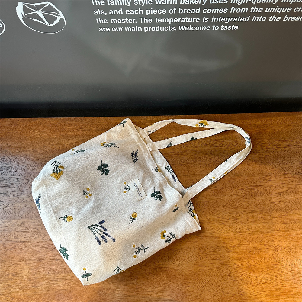 310231 estilo francés nuevo hombro bolsa de algodón ins estilo retro pequeña flor bordada bolsa de cosméticos bolsa de lona portátil