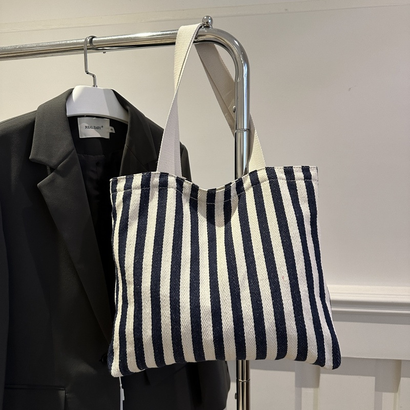 The new cross-border vertical striped commuter tote bag, hand-held shoulder bag, is fashionable and has a large capacity. It features an InS-style simple letter sail undefined