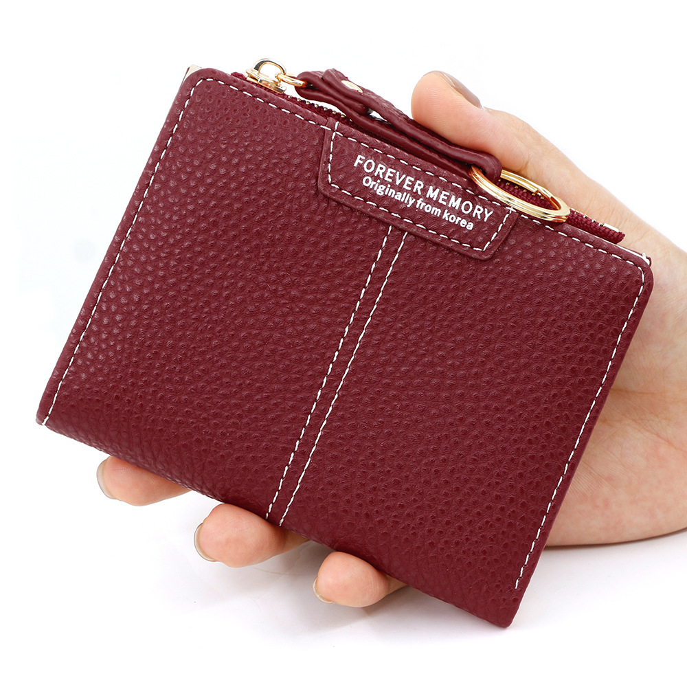 Versión coreana de la nueva billetera corta para mujer, llavero simple, billetera de monedas, billetera de dos pliegues para estudiantes al por mayor
