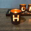 Black wooden creative set with letters, candle, decorations, jewelry