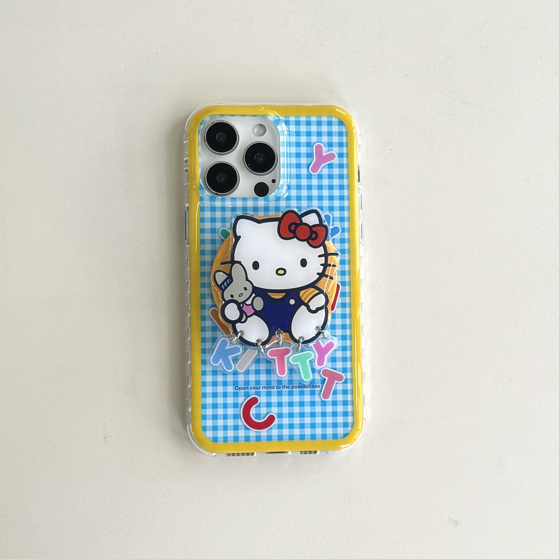 Lindo patrón de cuadros azul y amarillo Inglés KT gato para Apple 15ProMax funda para teléfono móvil 16Pro dibujos animados 14/13 nuevo 16