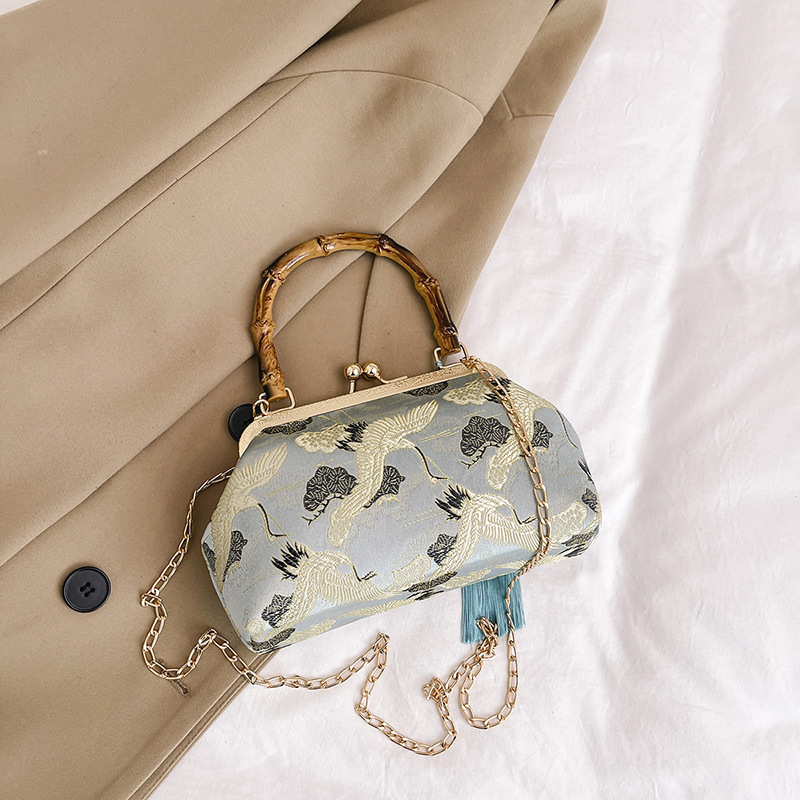 Elegante borsa a secchiello da donna con manico in legno e catena_voghion.com