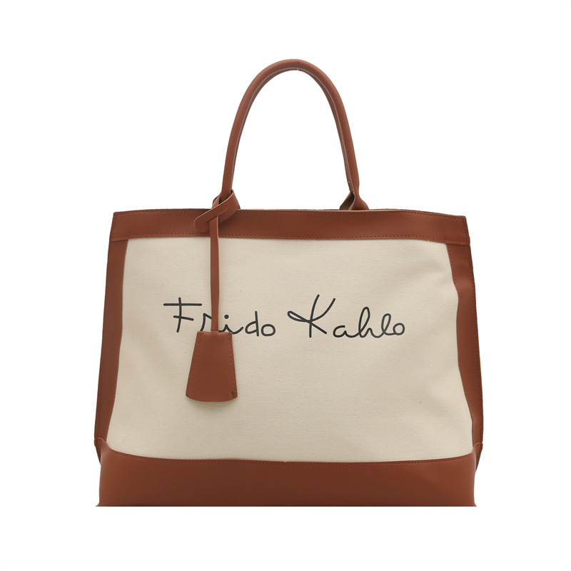 Casual retro alta sensación de bolsas portátiles de gran capacidad para mujeres 2025 nueva moda de color de viaje bolsas de mano