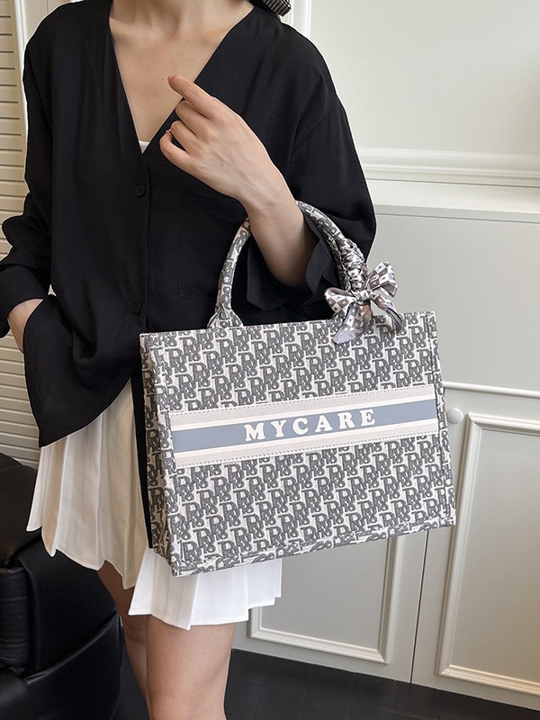Bolsos bordados de alta calidad para mujeres 2026 nuevas letras de tela transfronterizas retro bolsas de mano de transporte de gran capacidad