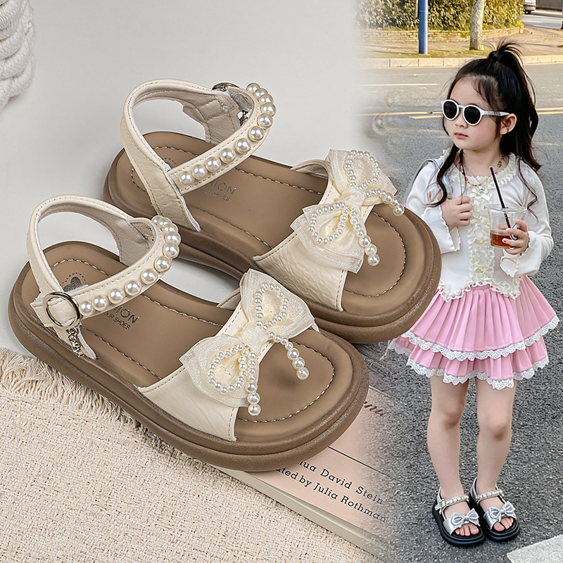 Zapatos de arco de niñas 2026 verano nuevos zapatos de princesa de estilo extranjero zapatos de moda para niñas zapatos de soleas suaves zapatos de soja