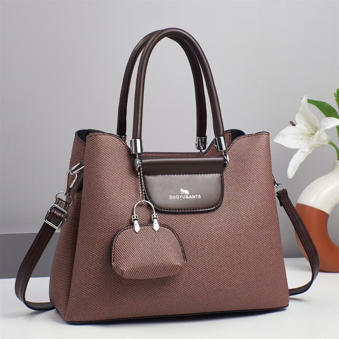 El nuevo bolso de mano para niños y madres está de moda en el bolso de hombro de textura, bolso de mensajero de diseño de nicho coreano de todo fósforo, comercio exterior