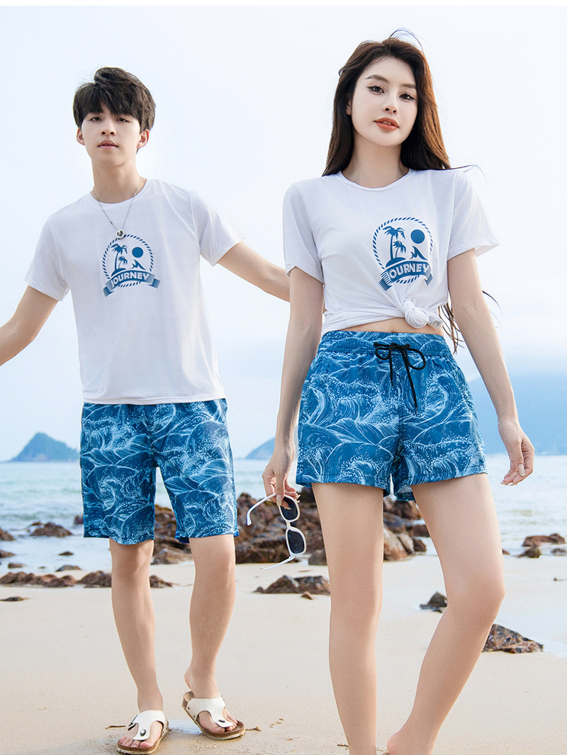 Pareja en stock, pantalones de playa rápidos y sueltos junto al mar, pantalones cortos deportivos de hombre, pantalones casuales de cinco puntos.