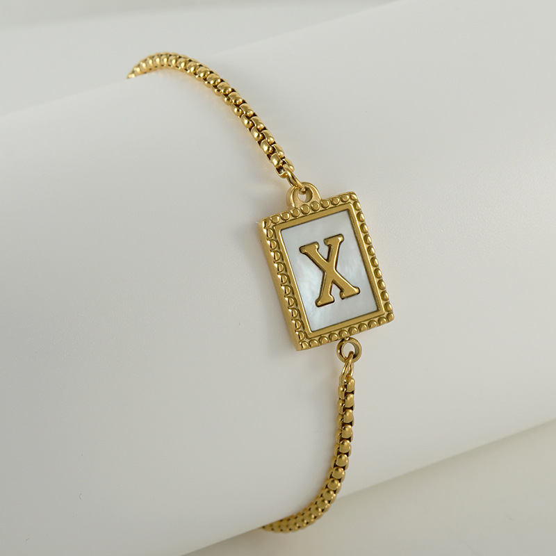 Nuevo europeo y americano transfronterizo de acero inoxidable 26 letras inglesas Shell pulsera personalidad todo partido titanio acero 18K cremallera