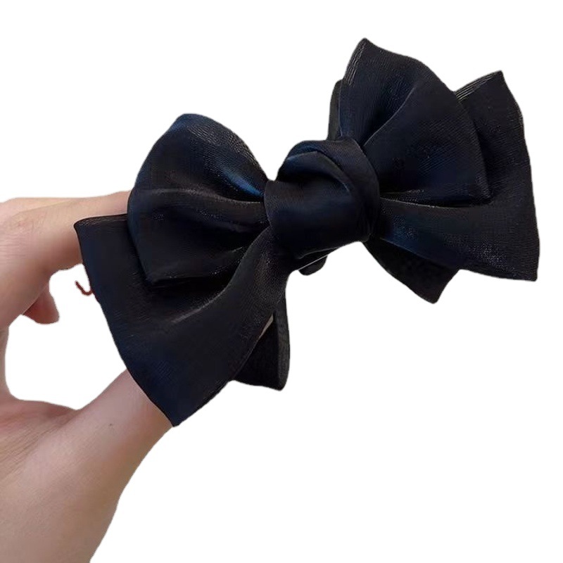 優雅な蝶結びの丸子の頭はネットの赤い2023年の新型の気質のヘアピンの女性の後頭部のクリップの頭飾りをつかみます。