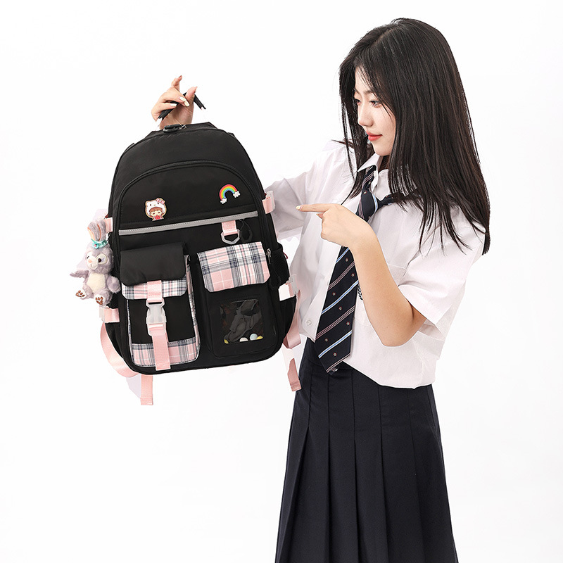 Nuevo estudiante de escuela secundaria estudiante cuarto grado chica gran capacidad ultra-ligero reducción de la carga espina dorsal estudiante mochila al por mayor