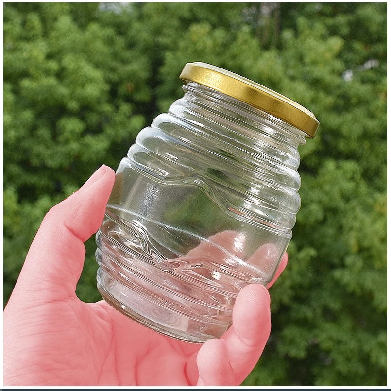 Botella de vidrio de miel de tornillo de suministro directo de fabricación de cubierta de estaño sellado de vidrio