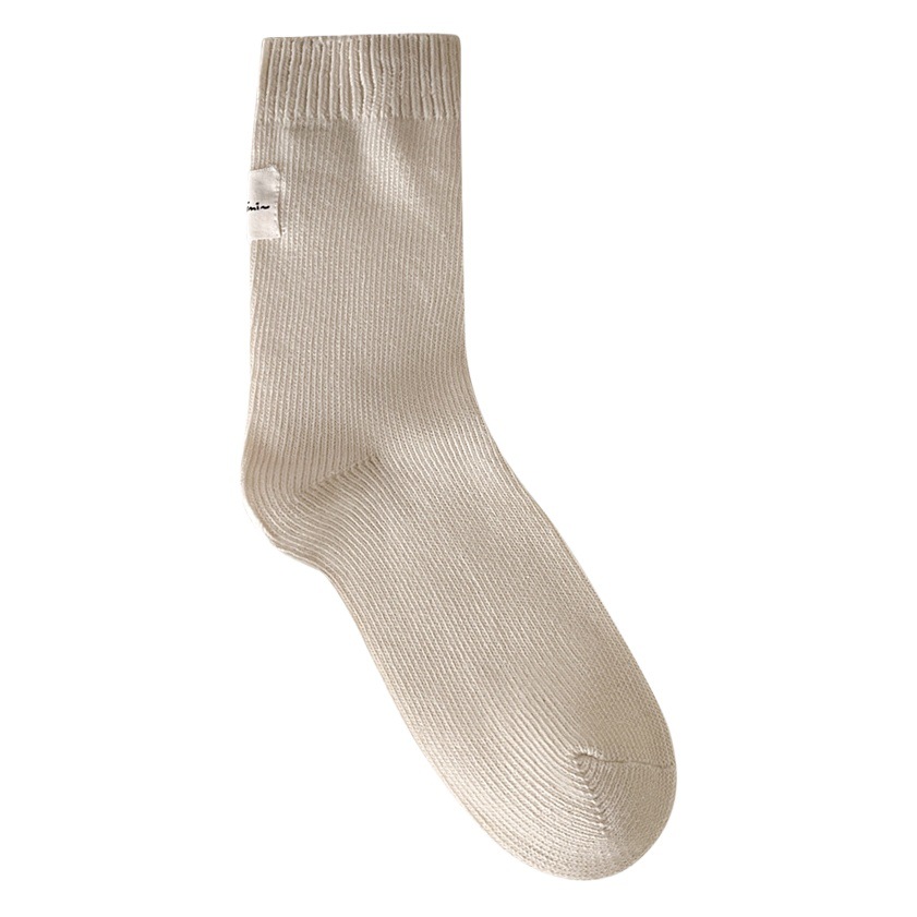 Otoño e invierno Nuevos calcetines de algodón absorbentes de sudor calcetines de pila serie de crema para mujer estilo ins Corea del Sur etiqueta de tela calcetines de media pantorrilla moda