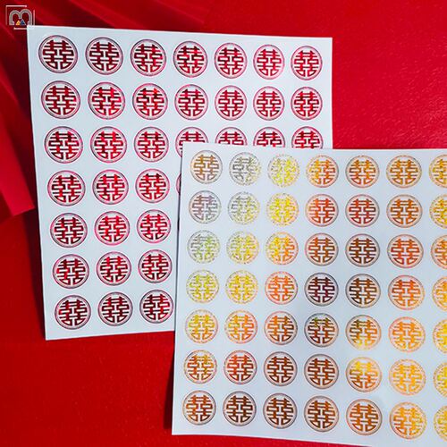 Wedding stickers with happy words on red envelopes and sugar box seals. Small happy words with glue on mini egg and apple cups