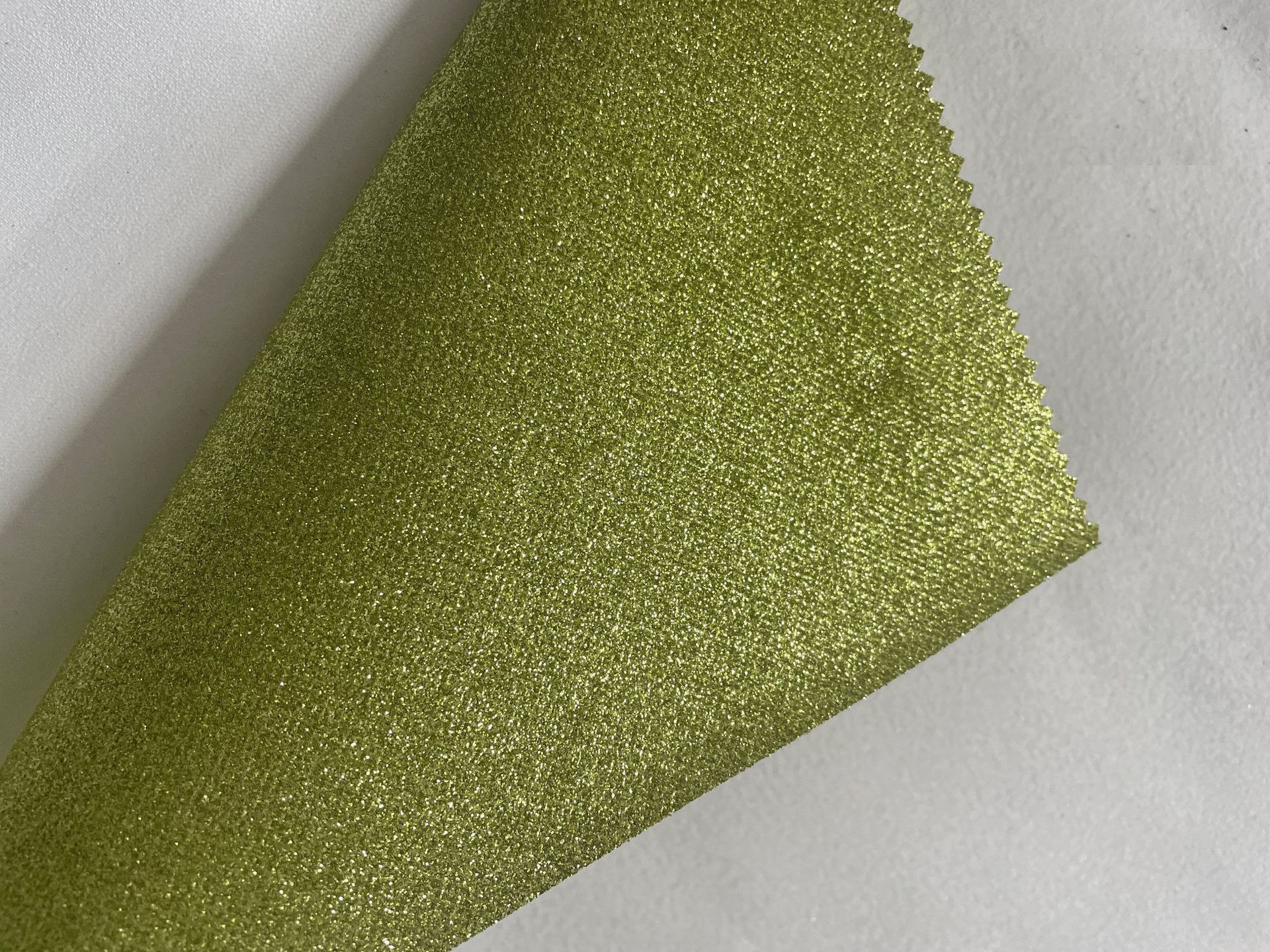 Suministro directo de fábrica de tela no tejida Glite Brillante Tela de lentejuelas Estuche para teléfono móvil Bolsa de cosméticos Accesorios para el cabello Decoración de ropa