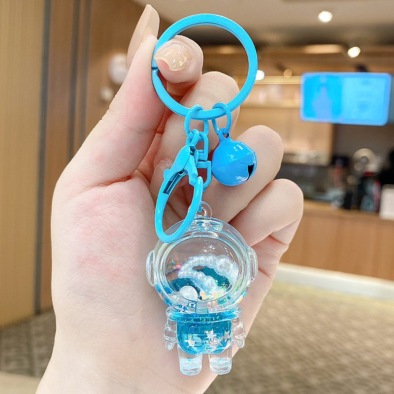 Caricatura en aceite líquido arena flotante botella mochila llavero delicado colgante accesorios accesorios máquina de muñecas pequeños regalos al por mayor