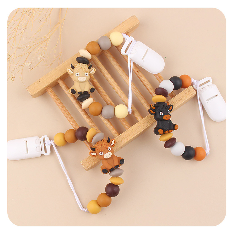 Productos infantiles de dibujos animados tridimensionales de vaca anti-caída cadena creativa bebé DIY silicona mordedor de goma molar calmar la cadena de tetina
