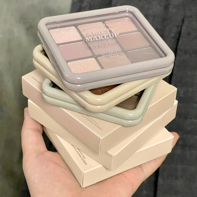 La nueva versión de la paleta de sombras de ojos de nueve colores Jiugongge perlado mate fino destello de sombra de ojos de 9 colores plato de barro de taro plato marrón naranja gran sitio femenino