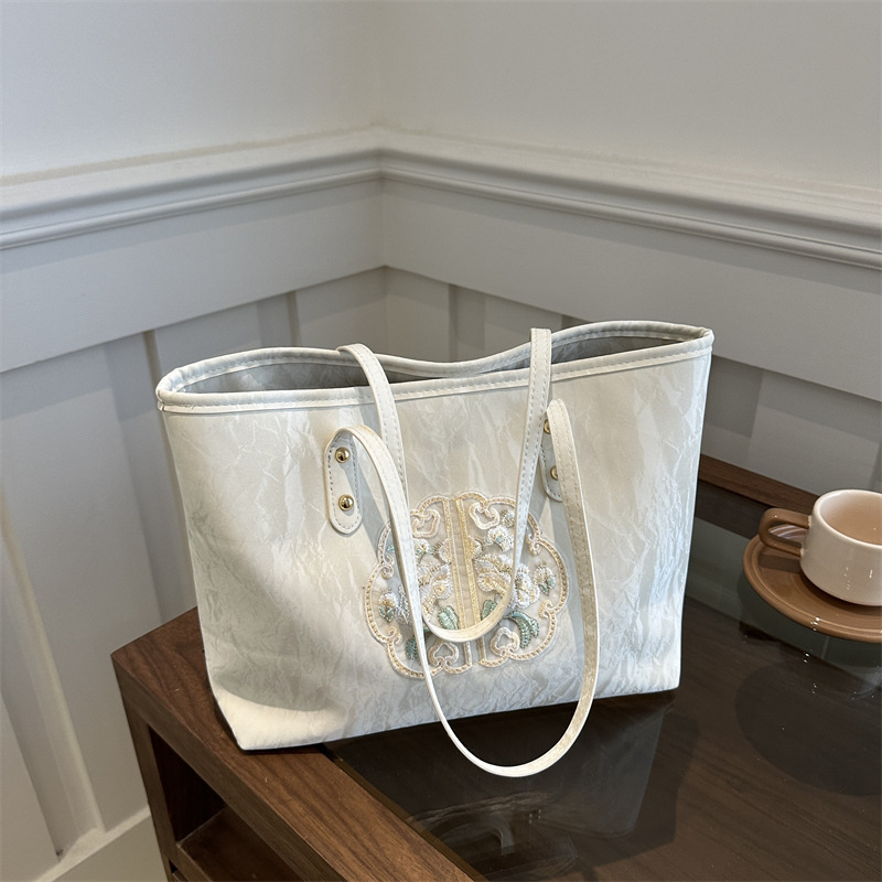 Bolsa de mano de alta calidad de alta capacidad de textura de transporte de verano 2024 nuevo estilo versátil para trabajar bolsas de hombro