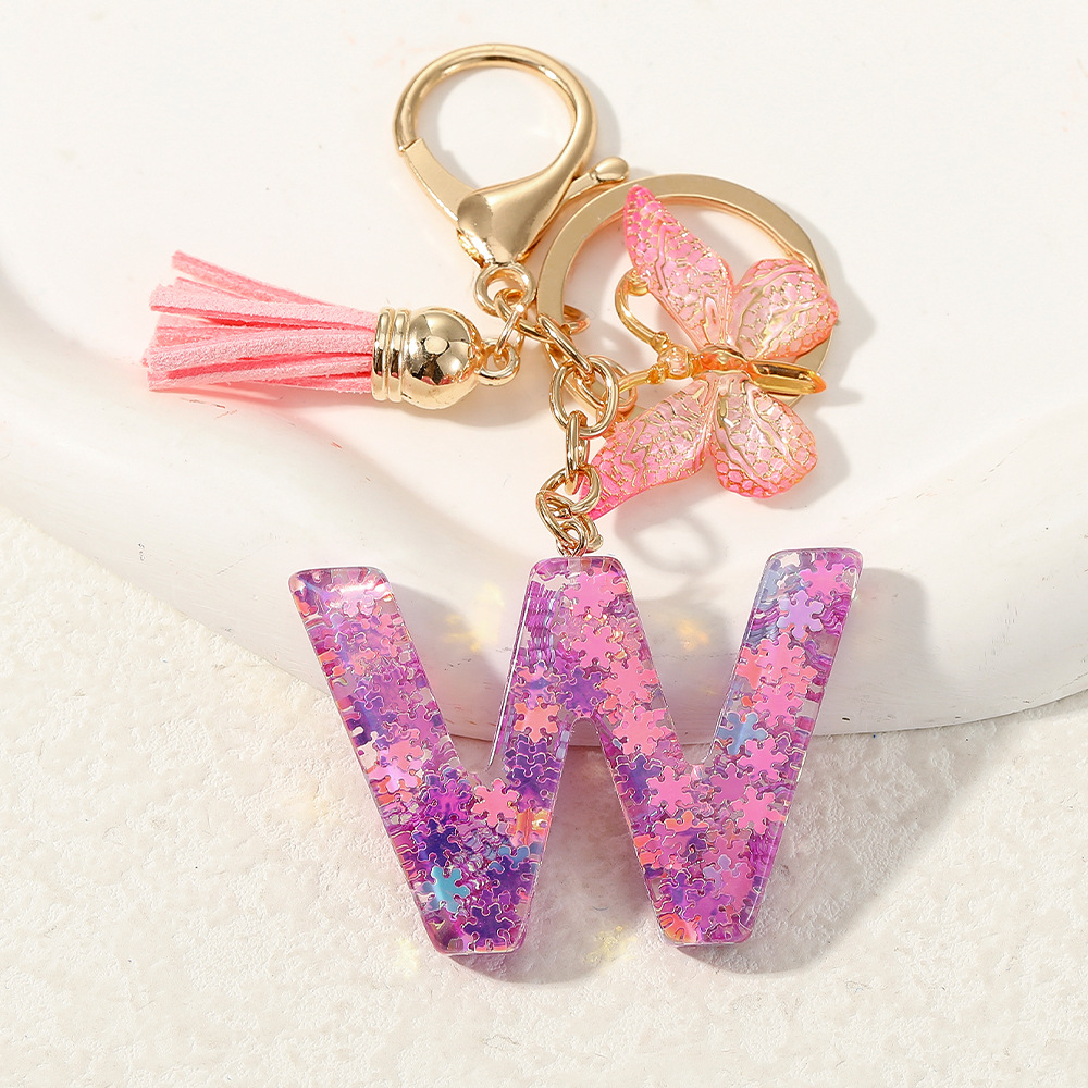 Nuevo color púrpura claro mezcla de polvo brillante letras inglesas resina llave colgante estilo simple mariposa borda colgante