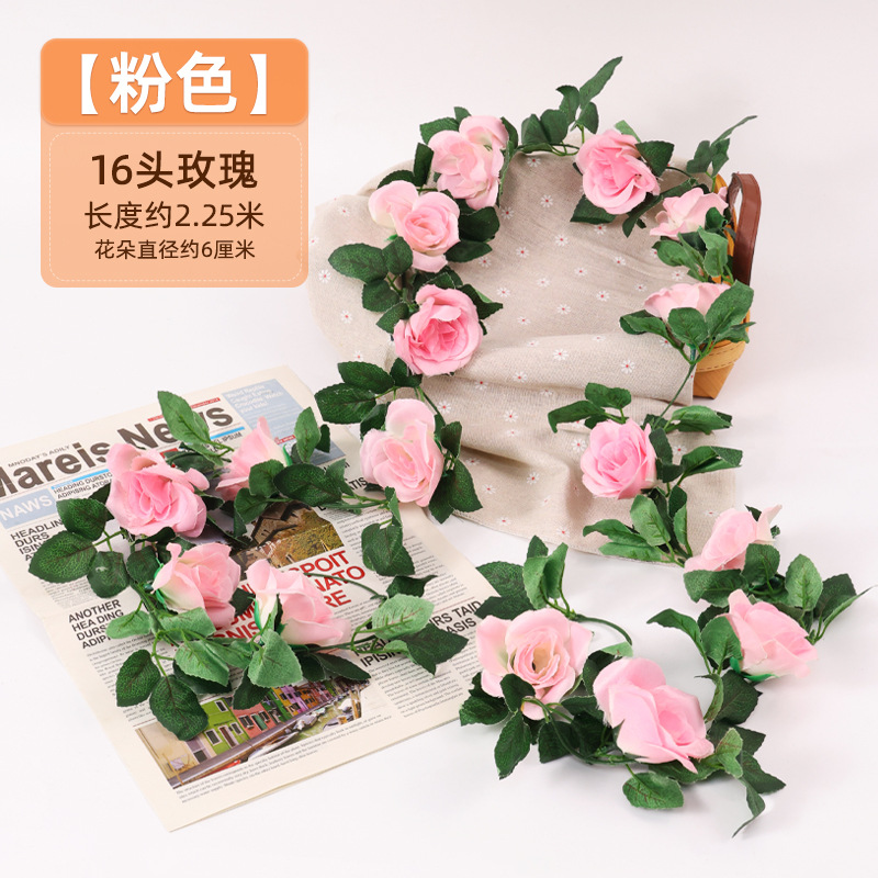 Simulación de flores falsas rosas de caña colgando la pared tubería de drenaje envuelta hoja verde que cubre la parte superior de la decoración de boda de plástico