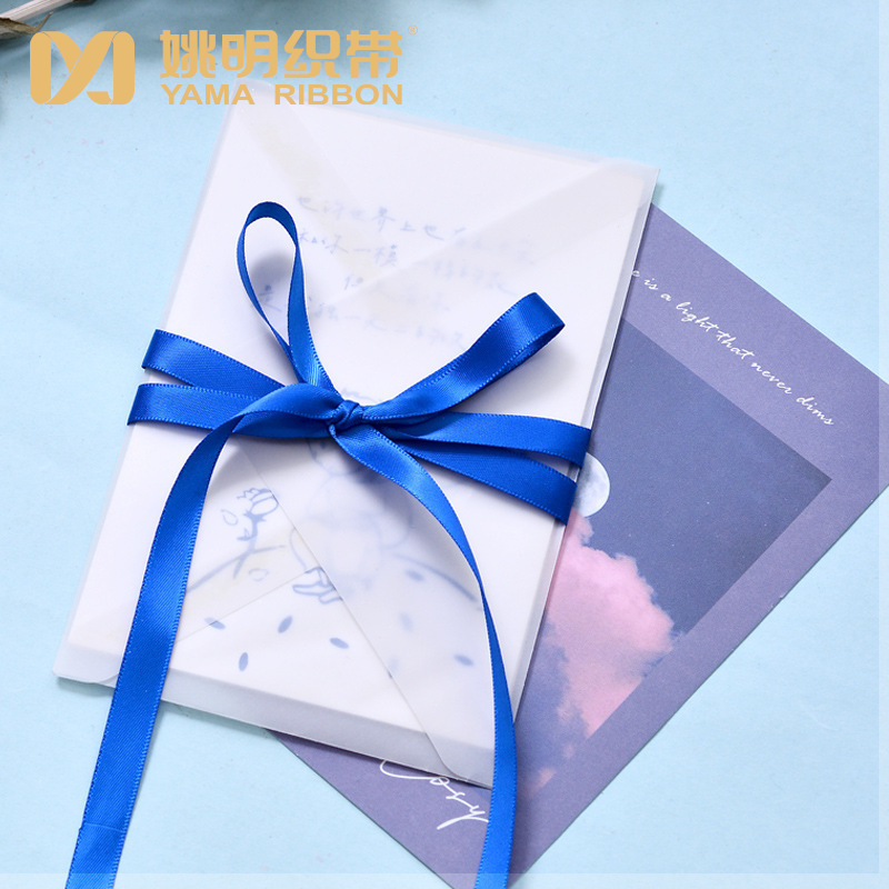 Cinta de satén azul de 9 mm de Yao Ming, la más vendida transfronteriza, para lazos de ramo, accesorios versátiles de decoración de ropa DIY.