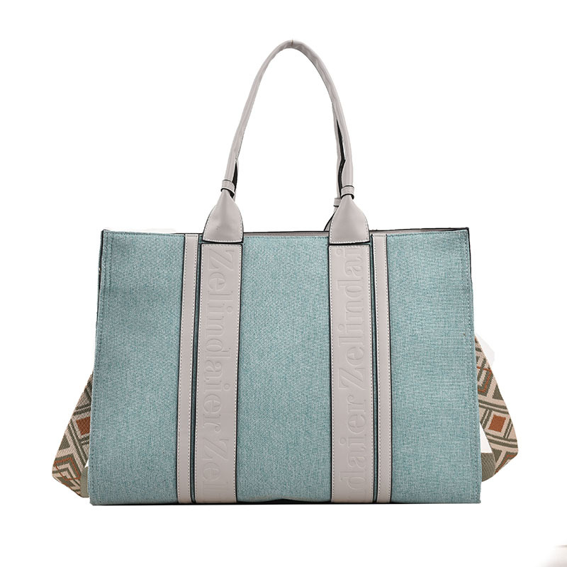 Bolso tote de lona de nuevo estilo con bloques de color, de gran capacidad para mujer, bolso cruzado de moda transfronteriza con sensación de alta gama para el trabajo y el transporte diario.
