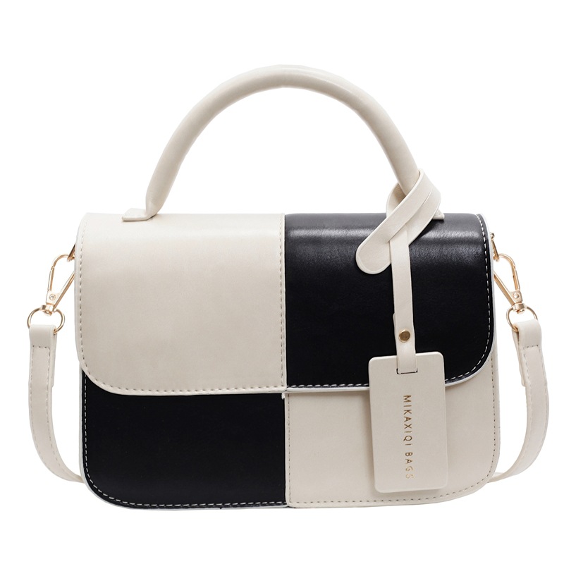 Bolso de mano coreano de color para mujeres 2025 nuevo nicho de textura universal bolso de hombro simple mochila casual