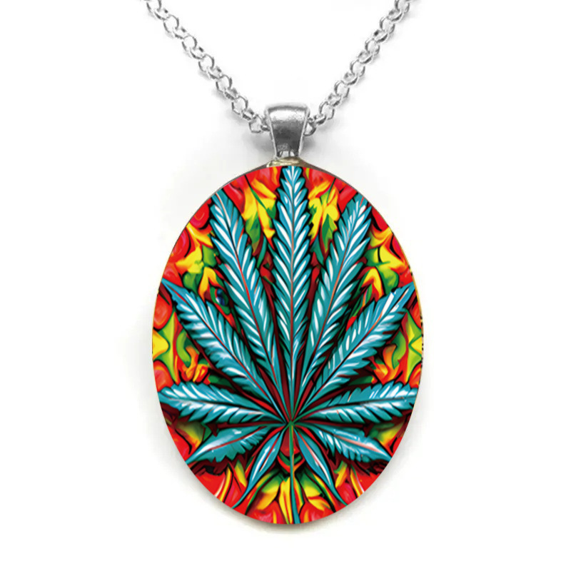 Oval glass pendant necklace with exaggerated leaf pattern