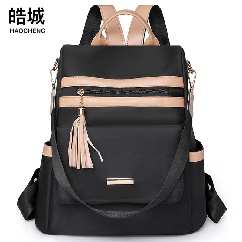 Mochila antirrobo de ocio al aire libre mujer 2024 nueva moda de nailon color de contraste borla viaje mochila de doble uso al por mayor