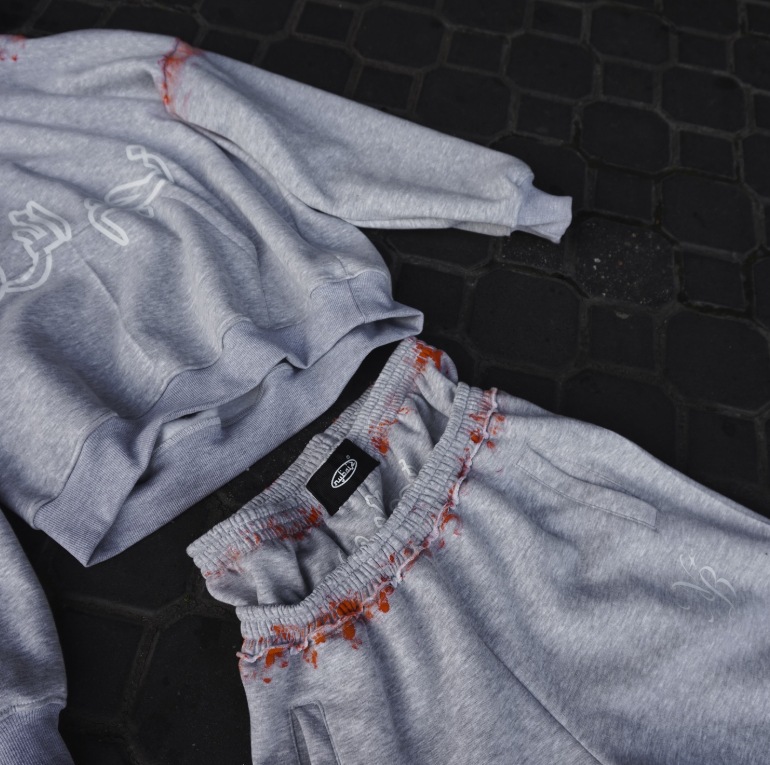 Europa y Estados Unidos explotaron transfronterizos personales calle gris impresión pantalones casuales sueltos de doble cintura pantalones con sudadera con capuz