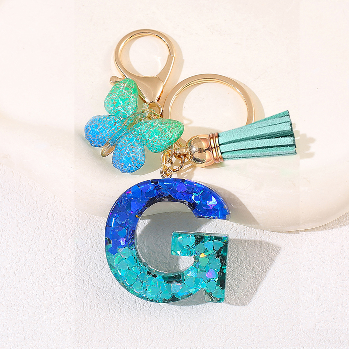 Amazon 26 letras llaveros bolsos damas colgantes colgantes sequillas letras bordas mariposa llaveros