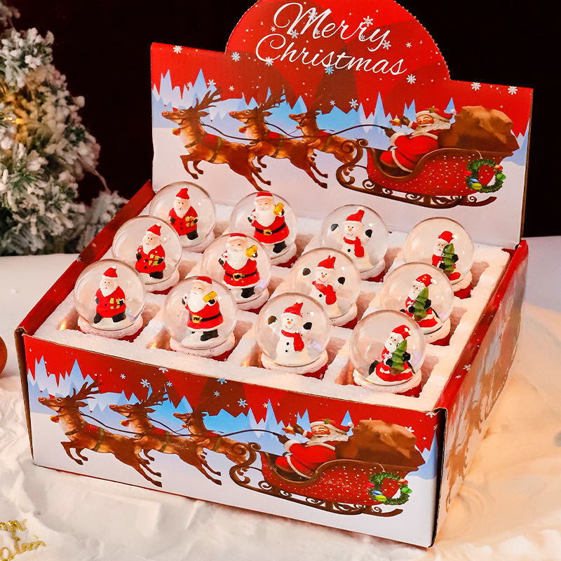 Una variedad de regalos de decoración de Navidad Navidad iluminante bola de cristal caja de música ventana diseño de velas lámparas de viento árbol de Navidad