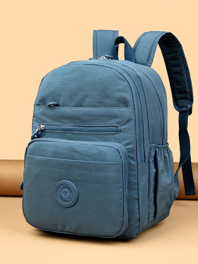 Mochila de hombro de comercio exterior 2025, nueva mochila de computadora simple de color sólido, mochila de escuela secundaria, mochila para hombres y mujeres.